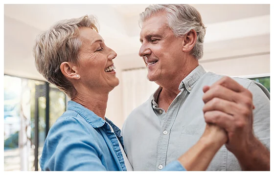 A happy older couple dancing