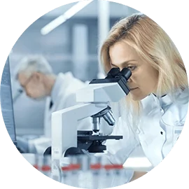 Researcher at a microscope